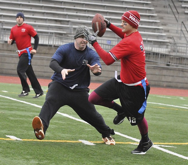 Valley Regional Fire Authority Firefighter Johan Friis tries to escape a Kent Police defender during the Battle of the Badges Holiday Football Game IX last Saturday at Auburn Memorial Stadium.