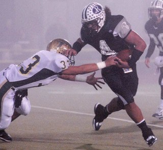 Auburn Riverside's Jake Pele tries to turn the corner for a gain as Auburn's Austin Embody defends during SPSL North action last season. Pele