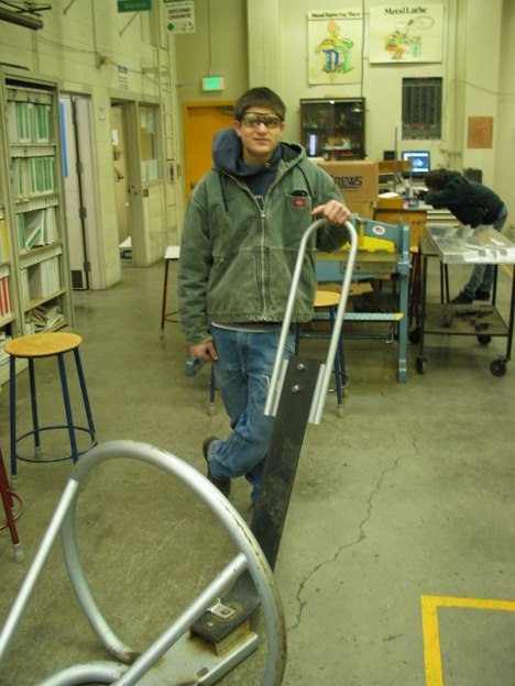 Auburn High senior James Babst stands by a repaired  football blocking/tackling sled. Babst and student welders repaired the sled