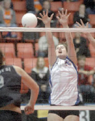 The Lions’ Caitlin Carr goes up to block a shot delivered by Mount Si during state volleyball action.