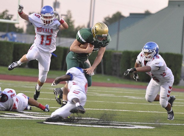 Auburn quarterback Justin Ioimo finds little room to roam against Kent-Meridian during the Trojans’  41-36 loss to the rival Royals last Friday night.