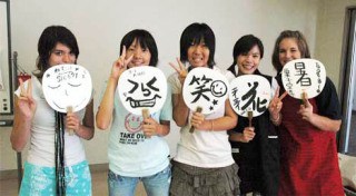Kent School District students and their Japanese hosts line up last summer for a photo after taking a calligraphy class together in Japan. From left is Trinity Smith (Kentlake High School)