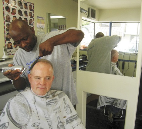 Stylist Randy Simon gives Jerry Helmick a trim at the Auburn Valley Barber Shop. The downtown barbershop