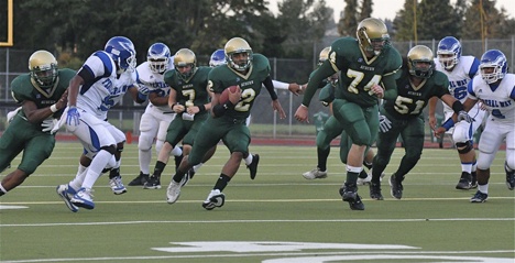 Auburn's Alphonse Wade gallops through a hole early in the game against Federal Way. The Trojans