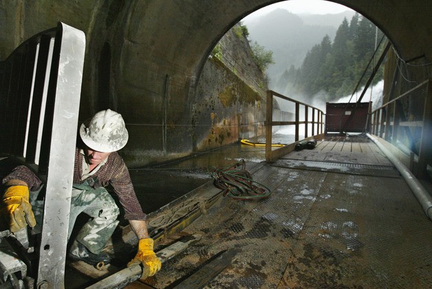 A driller loads equipment onto a forklift inside a 19-foot diameter tunnel at Howard Hanson Dam. Emergency repairs at the dam have been effective