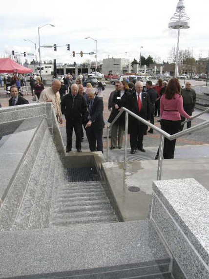 City officials and the public survey the newly-dedicated City Hall Plaza