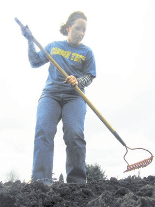 Angelique Moser cultivates her 10-by-20-foot plot in the Auburn Community Garden