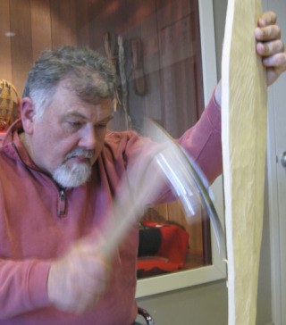 Greg Watson demonstrates the technique of adzing at the White River Valley Museum. Watson