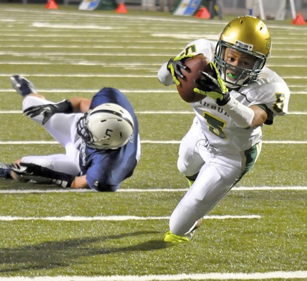 Auburn senior Harold Lee scores a touchdown during the Trojans semifinal loss to Bellarmine Prep at the Tacoma Dome.