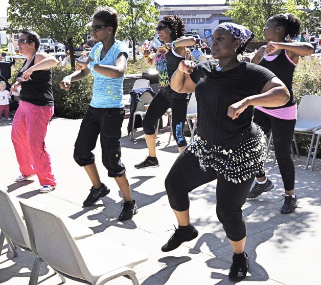 The Zumba group dancers from the Auburn Valley YMCA perform during the season opener of the Auburn International Farmers Market last Sunday at the Sound Transit Plaza.