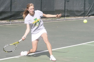 Sandy Dennett volleys against Kentwood’s Tess Manthou this past week at Auburn High School. Dennett finished up her season undefeated with a 14-0 record.