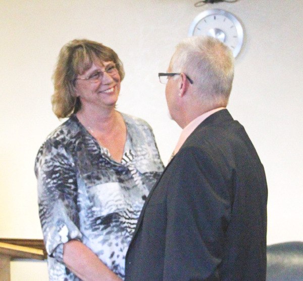 Pacific Mayor Leanne Guier is congratulated by Councilmember John Jones. The Pacific City Council voted 5-0 to appoint Guier to fill out the rest of Cy Sun's term