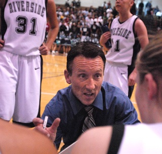 Former-Auburn Riverside girls basketball coach Ed Rosin talks to the girls during a time out. The team is currently looking for a new head coach.