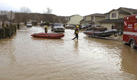 Rescue personnel from the Valley Regional Fire Authority checked homes on White River Drive in Pacific to see if residents needed help during last winter's flooding.