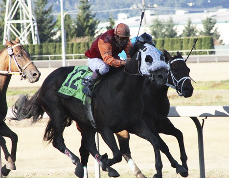 Gallyn Mitchell guides Assessment to victory in the 74th Longacres Mile on Sunday. Assessment came from the No. 12 hole and off the pace to take the prize.
