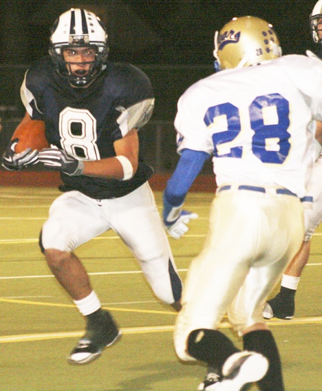 Ryan Adams gets ready to juke a Tahoma defender at Auburn Memorial Stadium last Friday.