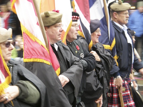 The Scottish-American Military Society march proudly down Main Street during last Saturday’s soggy Veterans Day Parade.