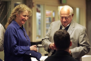 Baseball Hall-of-Famer Tommy Lasorda signs a ball for Sandra Jacobson