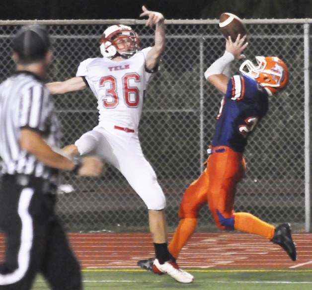 Auburn Mountainview's Skyler White hauls in a touchdown pass over Yelm's Greg Martin during the Lions' 29-12 win on Sept. 23.