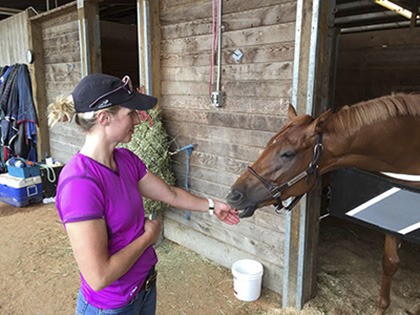 Monique Snowden plays with Thetrailerguy at her barn Thursday. Thetrailerguy