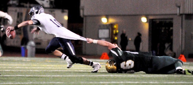 Auburn's Daniel Frunchak tries to pull down Auburn Riverside's Kevin Thomson during Friday's SPSL North 4A game.