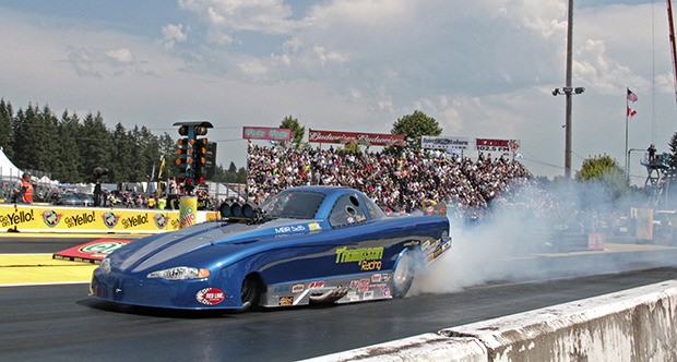 Top Alcohol Funny Car driver Clint Thompson smokes the tires of his Monte Carlo as he prepares to take on Shane Westerfield in the quarterfinals at the 27th NHRA O’Reilly Auto Parts Northwest Nationals at Pacific Raceways.