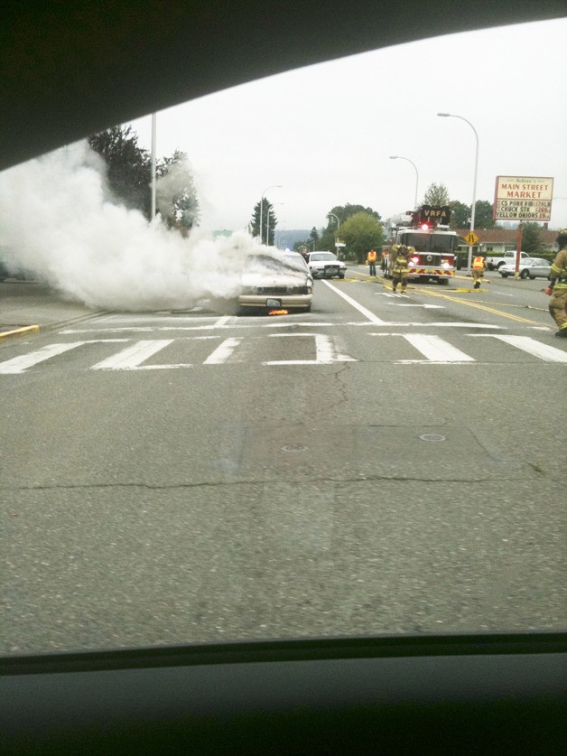 Smoke billows from a car as VRFA firefighters work to contain the fire Wednesday morning in Auburn. The driver was not hurt. Passerby Jason Brozovic caught this image from his cell phone.