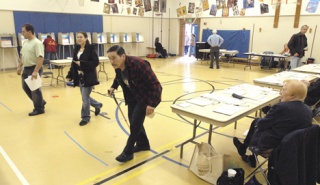 Voters get ready to cast their ballots at the polling place at Pioneer Elementary School early Tuesday. Record voter turnout was expected in King County and throughout the state for the general election.