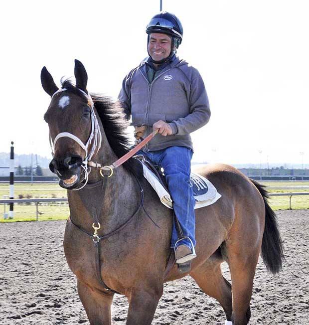 Exercise rider Pedro Vera Enriquez takes one of trainer Jeff Metz’s Thoroughbreds for a gallop at Emerald Downs last week. The Auburn track opens its 21st season Saturday
