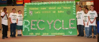 Students from Matt Roy's students created a large 'go green' message to fellow students about the milk and juice carton recycling campaign at Ilalko Elementary School.