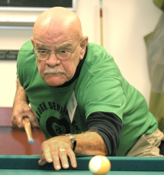 Ron Lemmen from the Auburn Senior Activity Center’s pool team watches his shot go in during Tuesday afternoon’s 8-ball billiards showdown between the seniors and the Auburn Parks