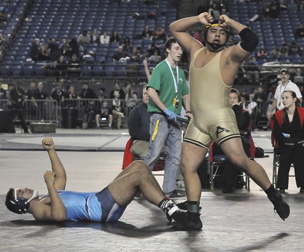 Auburn senior Mario Luevano celebrates his 220=pound championship win over Meadowdale's Tim Smith.