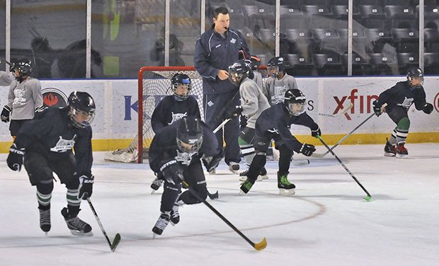 T-Birds assistant coach Matt O’Dette whistles the 9-10 year old players to go during recent drills at the Seattle Thunderbirds Hockey School at the ShoWare Center.
