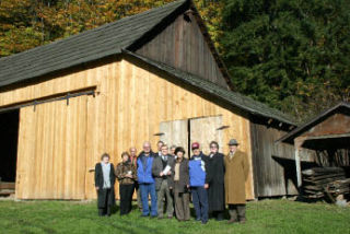 County and local officials gather at Mary Olson Farm. The historic location grew by six acres after the King County Council transferred the land to the city.