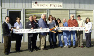 Employees and owners of Sisson Press joined Auburn Area Chamber of Commerce representatives and Mayor Pete Lewis in celebrating the opening of the business