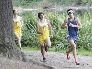 Auburn Riverside’s Julian-Blake Cowan leads Tahoma’s Phil Lussier and Kelton Sears this past Wednesday at Lake Wilderness park in Covington. Cowan held on for first place