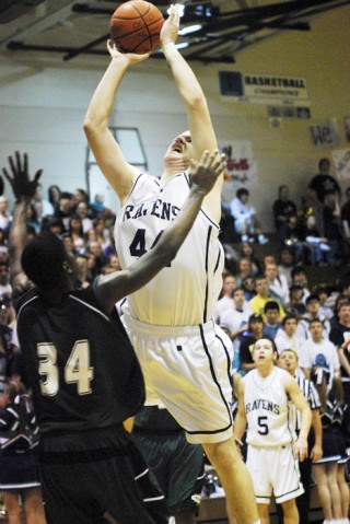 Auburn Riverside's Sam Melick shoots over Auburn's Iszia Johnson during SPSL North action.