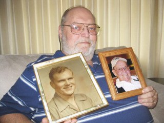 Jim Scobee shows two photos of his father