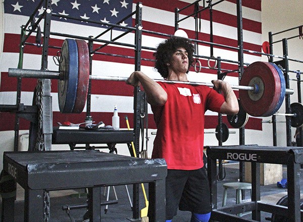 Auburn Riverside sophomore Harrison Maurus practices weightlifting at Alpha Strength and Conditioning.