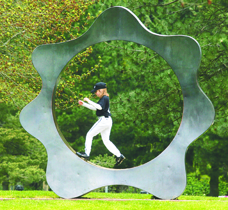 A baseball player wanders to play around on a sculpture at Game Farm Park. Auburn recently was honored as one of 93 Playful City USA communities.