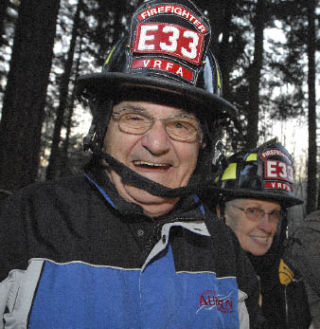 Auburn City Councilmember Gene Cerino and Algona City Councilmember Lynda Osborn don firefighter hats before the groundbreaking for the new Valley Regional Fire Authority Lakeland Fire Station 33 on Tuesday.