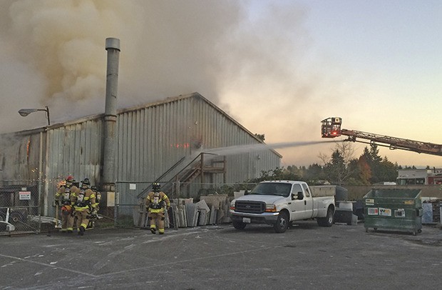 Firefighters fought and contained a large warehouse fire near the Auburn Adventist Academy on Tuesday. The cause of the fire remains unknown.