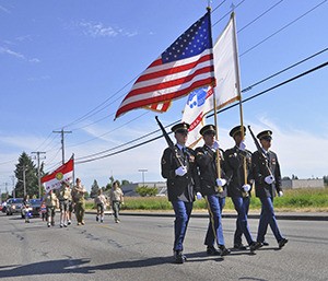 An Army color guard opens the 2014 Pacific Days Grand Parade.