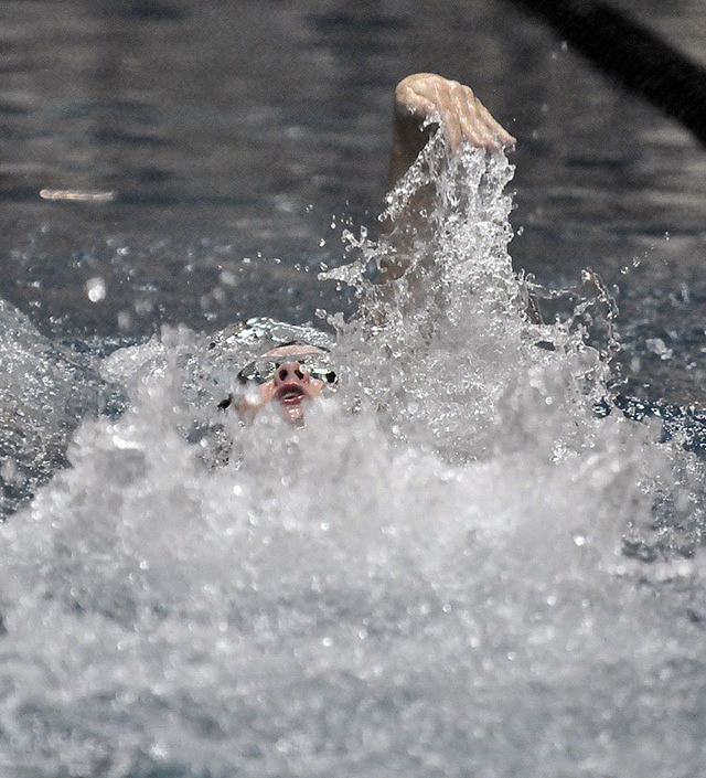 Auburn High School’s Jayden Henry parts the water during the leadoff backstroke leg of the Trojans’ 200-yard medley relay at the recent All-City swim meet at the Auburn Pool. Auburn won the relay in a district-qualifying time of 2 minutes