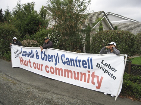 Protesters stand in front of the home belonging to Tom Cantrell