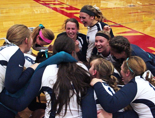 The Auburn Riverside volleyball squad celebrates after capturing the Washington State 3A title on Saturday.