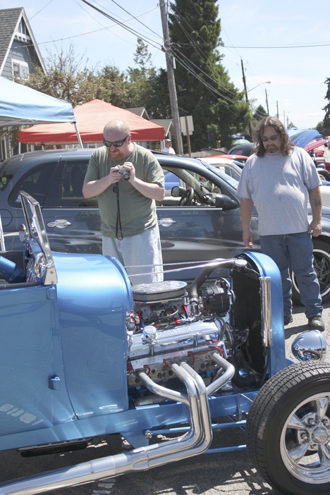 Chip Myers and Stephen Moore enjoy Darcie and Andy Hanson’s ’29 Ford Roadster during the Algona Days car show.