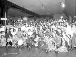 The townsfolk dressed the part of ‘hayseeds’ for a ball in this 1912 photograph taken by Arthur Condict Ballard. His collection of photos is on display at the White River Valley Museum through April 14.