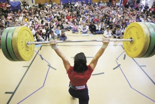 Olympic weightlifter Melanie Roach of Bonney Lake hoists 187 pounds in the clean-and-jerk lift in front of an October all-school assembly at Washington Elementary School. In the Beijing Olympics