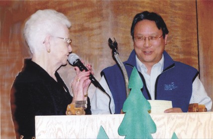Dottie Quimby presents Dr. Ronald Louie with a check of $10